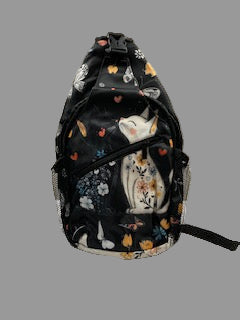 Black floral-patterned backpack on a white surface against a gray wall