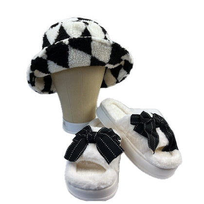 White slippers with black bows and a matching checkered hat on a mannequin head against a white background.