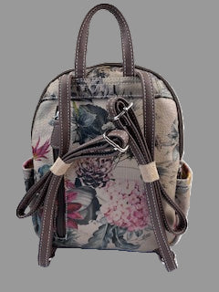 Floral patterned backpack with brown straps on a white background