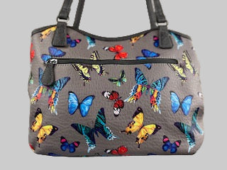 Gray handbag with colorful butterfly pattern on a light gray background